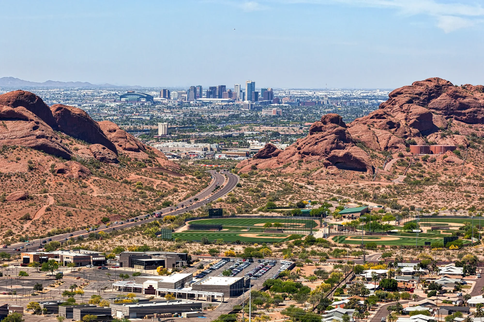 The red buttes of Papago Park with downtown Phoenix beyond