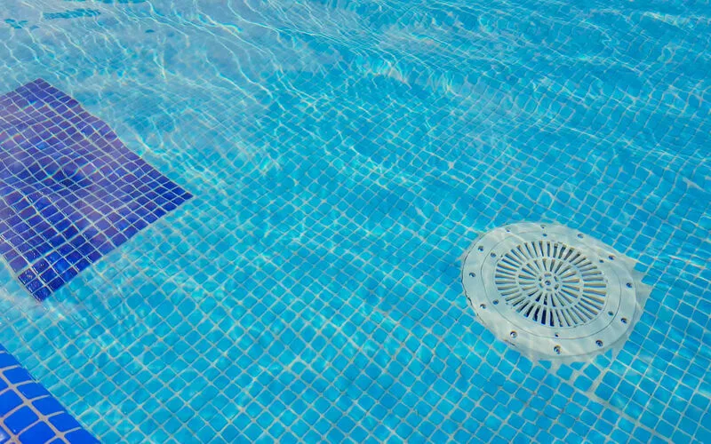 Swimming pool and patio in a newer suburban back garden