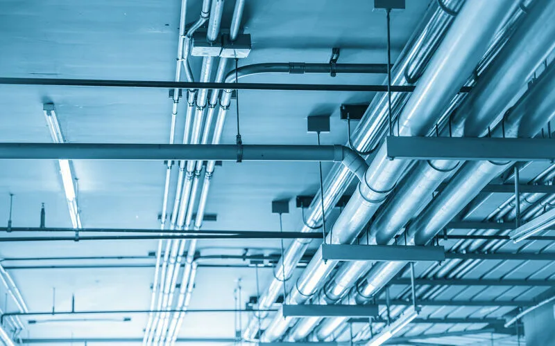 Water lines running overhead inside a building